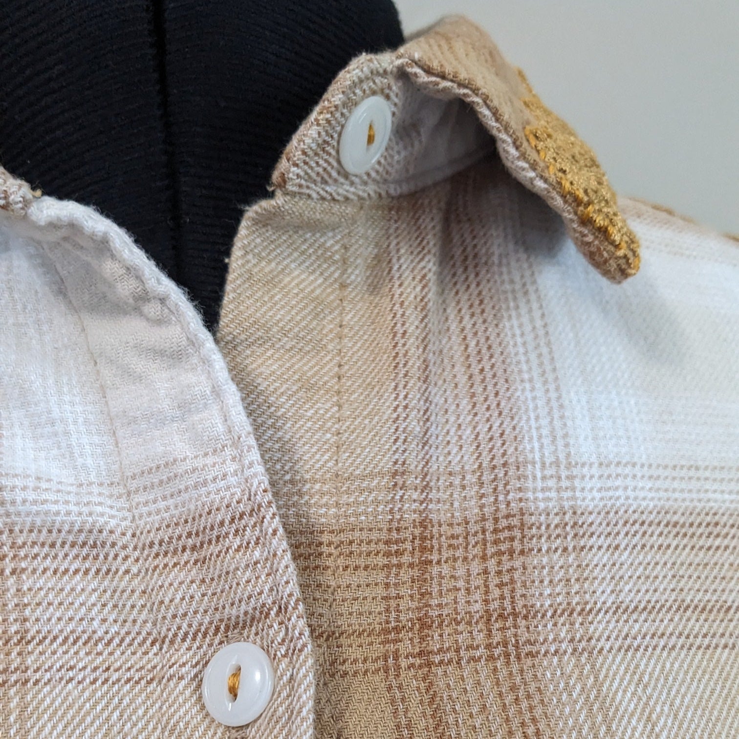 Close-up of a plaid shirt with a focus on texture and pattern.