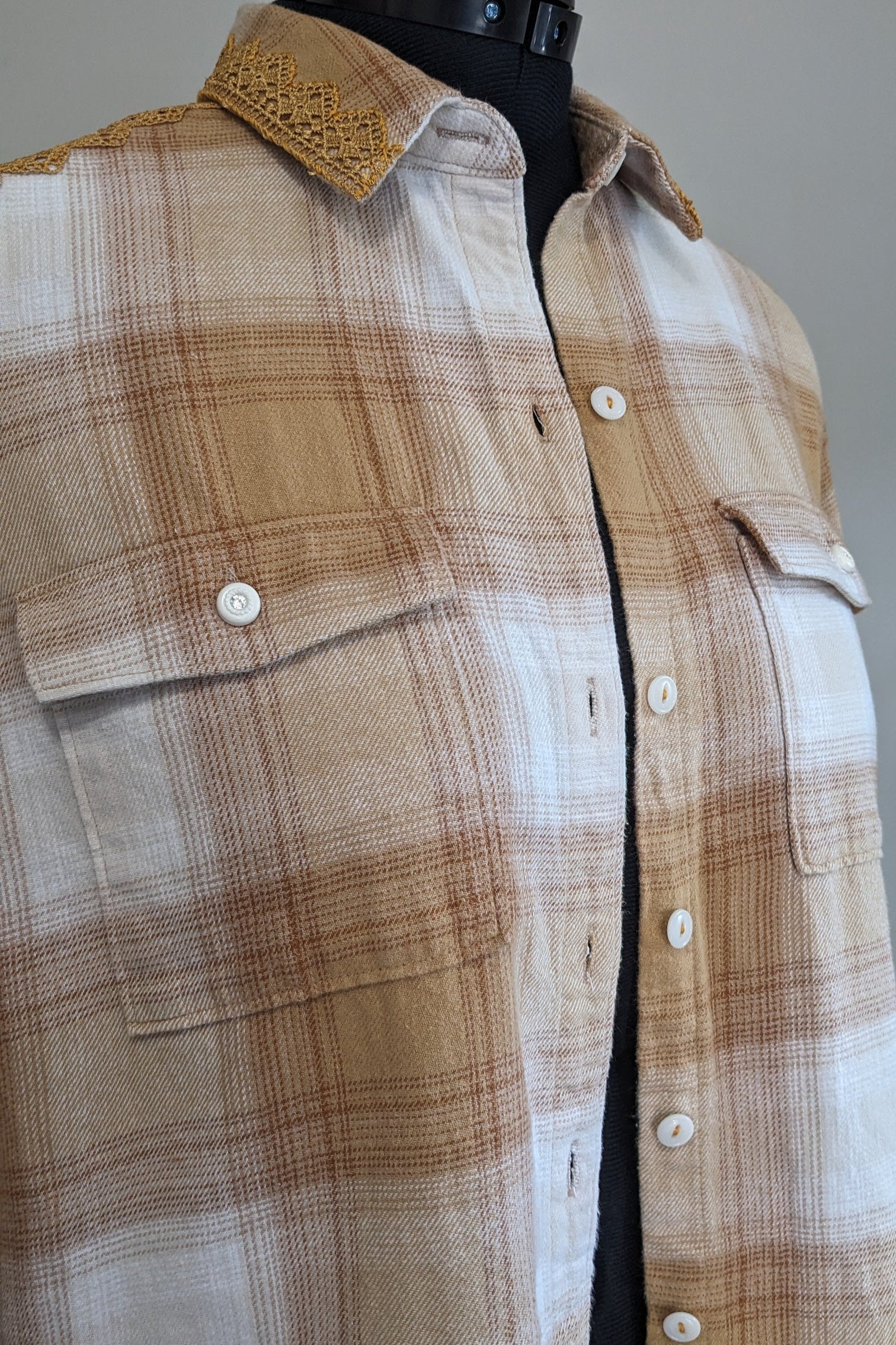 Plaid shirt on a mannequin with a plain background